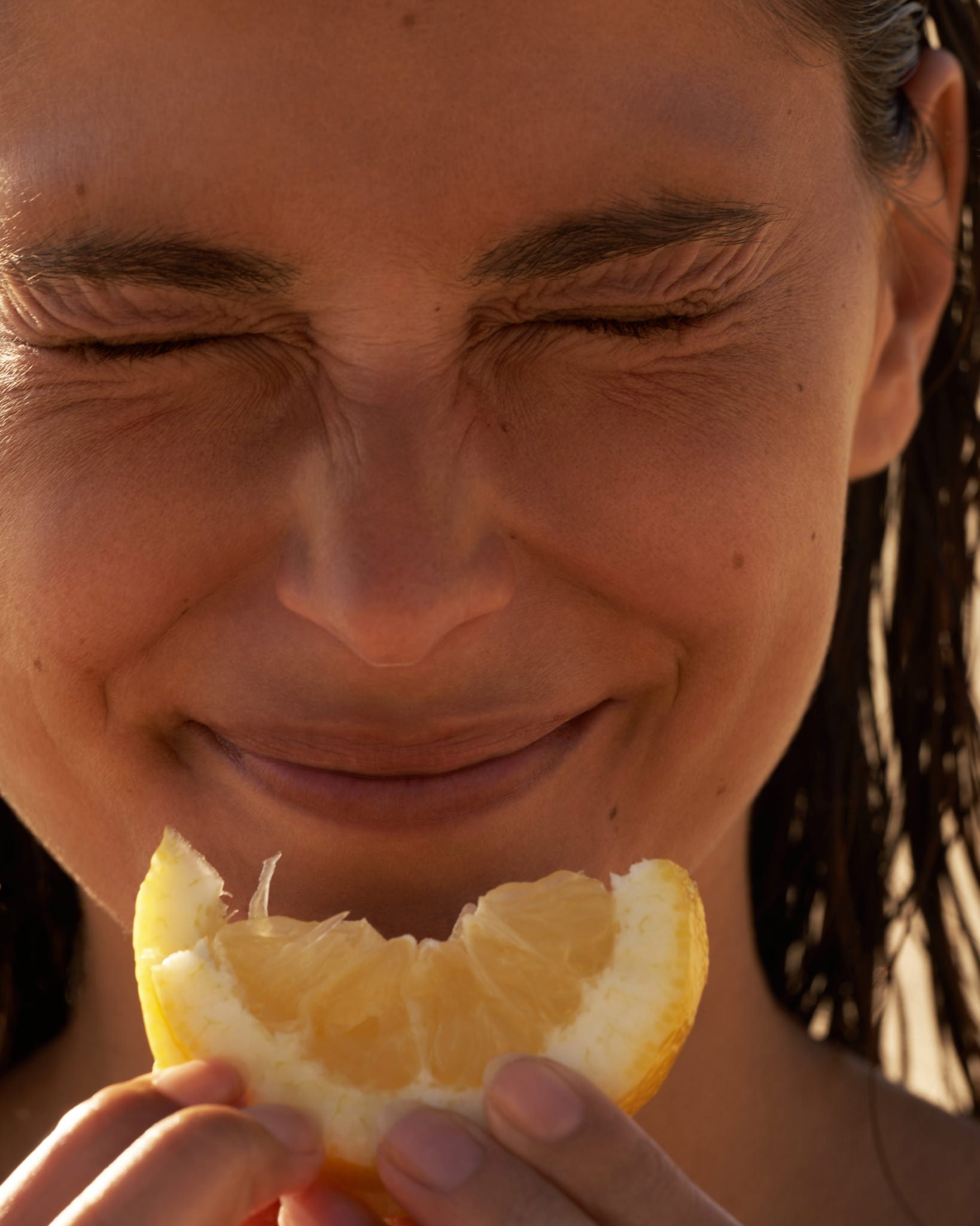 A warm close-up portrait with citrus